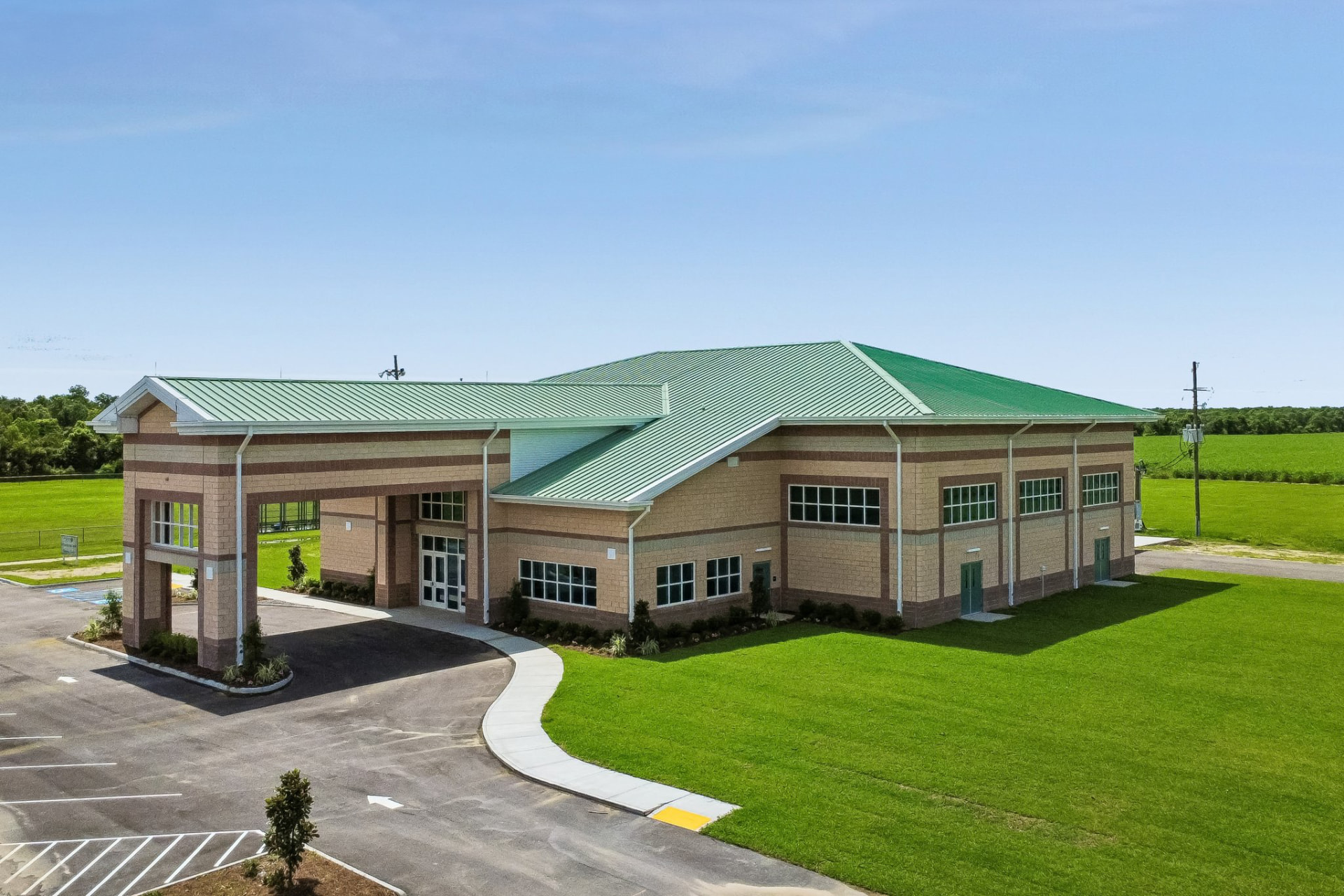 New community building with green metal roof and covered entry